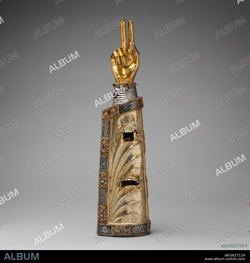 Arm Reliquary. Culture: South Netherlandish. Dimensions: 25 1/2 x 6 1/2 x 4 in.  (64.8 x 16.5 x 10.2 cm). Date: ca. 1230.
This container for the precious remains of a saint adopts the form of the relics it likely once held--fragments of a saint's arm. When the reliquary was set on an altar, the sacred bones could be perceived in the two windows, once covered with crystal, which are cut into the silver. When carried in procession, the imposing image of the saint's arm raised in blessing could be seen easily by the faithful, even from a distance. The rich combination of materials used for the sleeve of the saint's vestment typifies goldsmith's work produced in the Meuse Valley, now a part of modern Belgium, and is related to the style of Brother Hugo of Oignies, a celebrated thirteenth-century artist.