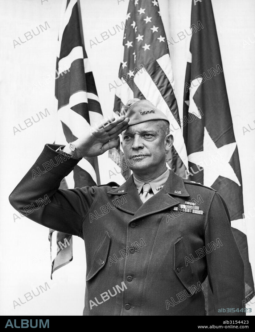 United States:  c. 1943 Four star General Dwight D. Eisenhower stands and salutes the flag.
