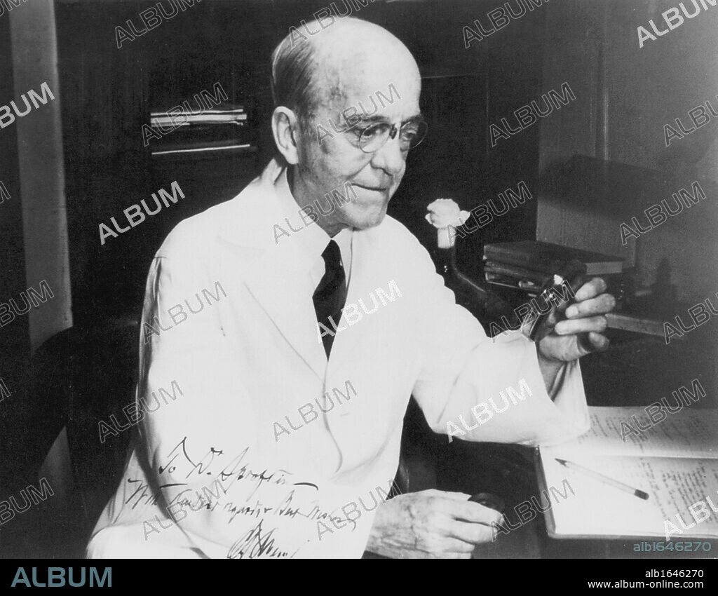 Oswald Theodore Avery (1877-1955) Canadian-born American bacteriologist and molecular biologist at work in laboratory examining a petrie dish of culture. A founder of immuno-chemistry.  Credit: World History Archive/Rockefeller University Archives.