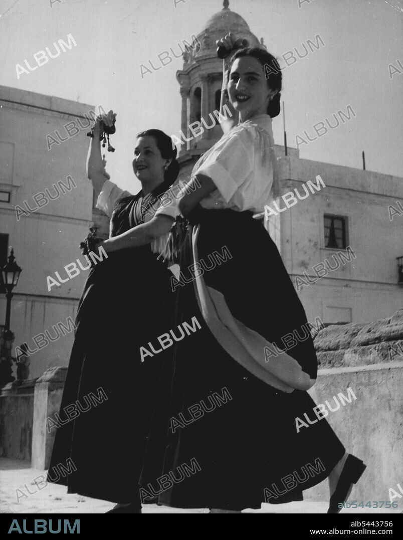 Women Of 'Spain -- They remove the heavy black hood for dancing: here, Margarita Cano and Araceli Jimenez form Cadiz perform a country dance; the Cadiz dancers with "Winged feet' were famous in ancient Rome for their grace and charm. September 3, 1951. (Photo by Sequeria, Camera Press).
