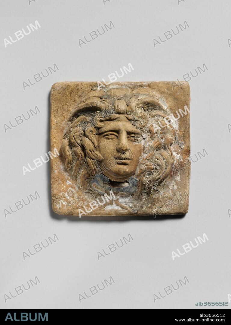 Terracotta relief plaque with head of Medusa. Culture: Greek. Dimensions: H. 2 7/16 in. (6.2 cm.)
L. 2 1/2 in. (6.4cm.). Date: 2nd century B.C..
Slightly chipped. A good deal of blue pigment remains on the throat, and a little above head.