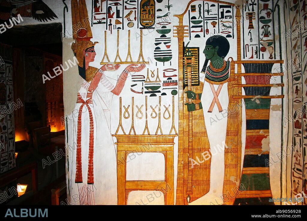 Wall Painting depicting, Nefertari and the God, Ptah. Inside the tomb (QV66) of Nefertari, Great Wife of Pharaoh Ramesses II, in Egypt's Valley of the Queens. It was discovered by Ernesto Schiaparelli in 1904. It is called the Sistine Chapel of Ancient Egypt. In the Valley of the Queens, Nefertari's tomb once held the mummified body and representative symbolisms of her, like what most Egyptian tombs consisted of. Now, everything had been looted except for two thirds of the 5,200 square feet of wall paintings. ca. 1255 BC.