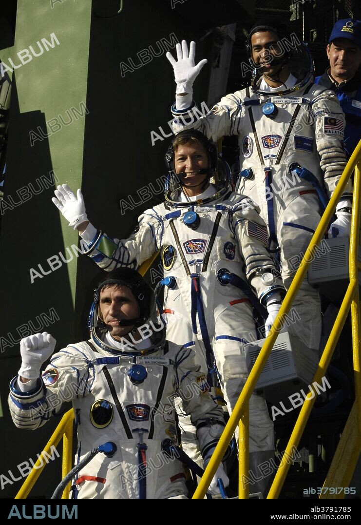 Expedition 16 Commander Peggy Whitson (middle), Flight Engineer and Soyuz Commander Yuri Malenchenko (bottom) and Malaysian Spaceflight Participant Sheikh Muszaphar Shukor wave farewell at the steps of the Soyuz rocket. The crew launched from the Baikonur Cosmodrome in Kazakhstan at sunset Oct. 10, 2007, in their Soyuz TMA-11 spacecraft bound for a docking to the International Space Station on Oct. 12. Whitson and Malenchenko will spend six months on the station while Shukor will return to Earth Oct. 21 with two of the Expedition 15 crewmembers currently on the complex. This marks the first time an ISS expedition will be commanded by a woman. This also marks the first time the both commanders of the joint mission between ISS Expediton 16 and STS-120 will be women (Peggy Whitson, and Melroy, respectively).