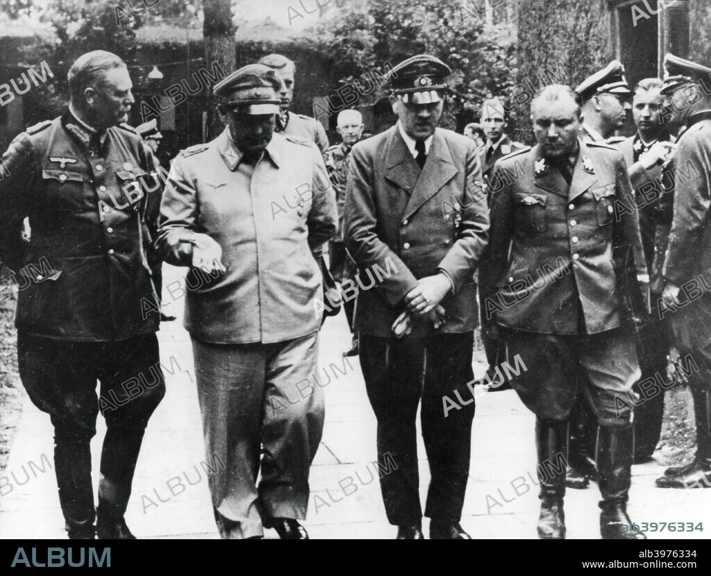 Adolf Hitler and senior Nazis, July 1944. The photograph was taken six days after the attempt on Hitler's life. On 20 July 1944, Colonel Count Claus von Stauffenberg left a briefcase packed with explosives in the briefing room of the 'Wof's Lair', Hitler's headquarters in East Prussia. Although the bomb exploded, Hitler escaped with only minor injuries. Stauffenberg and other officers implicated in the July Plot were arrested, tried and executed, some with terrible brutality. Hitler is pictured flanked by Field Marshal Keitel, Reichsmarschall Hermann Goering and Martin Bormann.