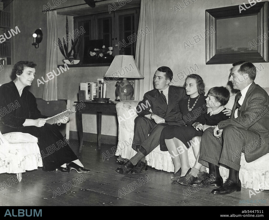 A Family Campaign Conference -- Mrs. Madeleine Sloane, daughter of the late Thomas A. Edison, is shown Sept, 2 in her home at West Orange, N.J., as she read a campaign speech to her family after launching her candidacy for the republican Congressional Nomination form New Jersey's 11th district. Seated opposite her (L to R) Are her son, Thomas Edison Sloane; Mrs. Thomas Edison Sloane; Michael Edison Sloane, Another Son; and John Eyre Sloane, her husband who is a New York investment Banker. March 9, 1938. (Photo by Associated Press Photo).
