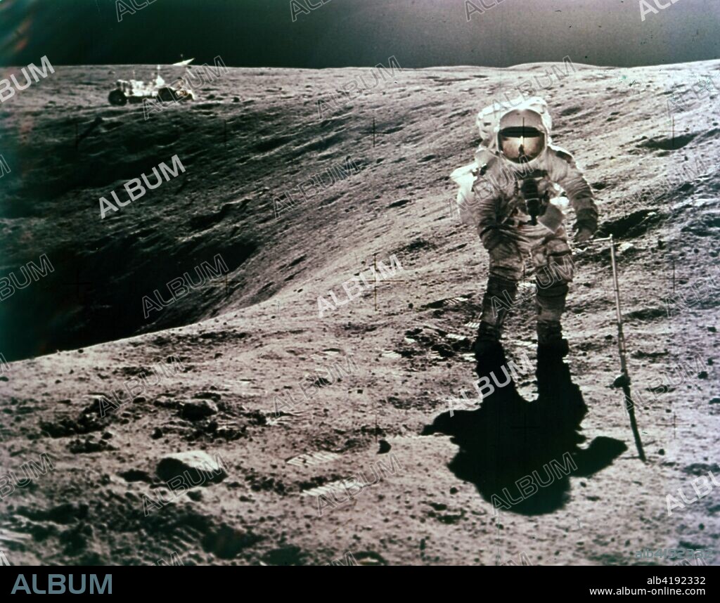 Astronaut Charles Duke at the Descartes landing site, Apollo 16 mission, April 1972. Charles Duke collecting lunar samples on the surface of the Moon, with the Lunar Roving Vehicle, on the rim of Plum crater, in the distance.
