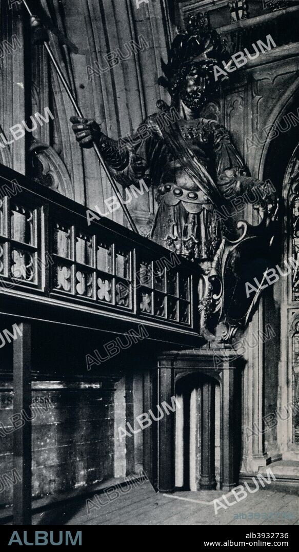 'Magog (Corineus), one of the two City giants burnt in the London Guildhall fire of Sunday, December 29th, 1940'. Gog and Magog, are associated with Guildhall. Legend has it that the two giants were defeated by Brutus and chained to the gates of his palace on the site of Guildhall. The earliest versions of Gog and Magog were destroyed during the Great Fire of London. They were replaced in 1708 by a pair of wooden statues carved by Captain Richard Saunders. It was these giants that were destroyed in the Blitz. From The Connoisseur, 1941 edited by H. Granville Fell. [The National Magazine Co. Ltd, London, 1941].