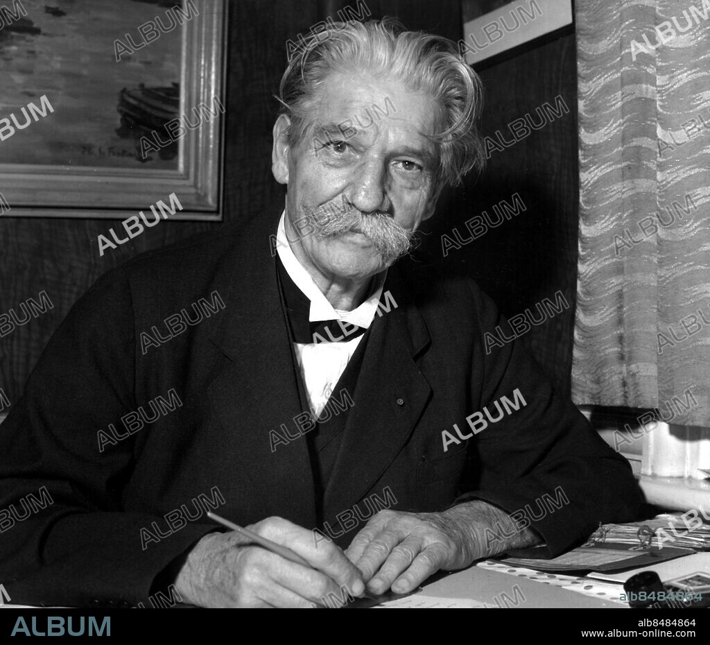 Orig.bildtext... SCHWEITZER WAITS IN A RESTAURANT. Dr. Albert Schweitzer, world-famous Nobel Peace Prize winner in London to receive an honorary order of merit from Queen Elizabeth, has set up his temporary office in the rear room of a London restaurant owned by a friend of his, Emil Metler. Hundreds of persons queued up to eat in the restaurant to catch a glimpse of the 80-year-old frenchman who has been called the world's greatest man. Photo shows: Dr. Schweitzer at his diningtable-writing table yesterday, catching up on his voluminous correspondence with his famous penholder. He is using Velin D'Alsace, from the country of his birth. Dr. Schweitzer received his O.M. from the queen today. He and president Eisenhower are the only non-british persons ever to receive the O.M. Anm. A Schweizer, 1875-1965, tysk teolog, filosof, läkare, missionär, musikforskare och organist. Nobels fredspris 1952 Mustascher persons: Albert Schweitzer sites: LONDON ;STORBRITANNIEN ;TYSKLAND*.