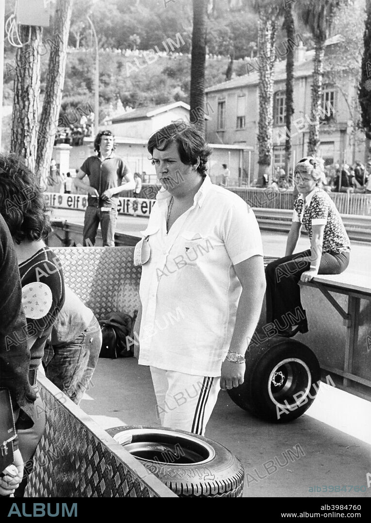 Lord Alexander Hesketh at the Monaco Grand Prix, 1973. Pictured in the pits at the edge of the circuit. Lord Alexander Hesketh at the headquarters of his team, Hesketh Racing. London, 1974. Hesketh inherited the family fortune in 1971 when he was aged 21. Together with Anthony Horsley, he set up a racing team called Hesketh Racing and bought a Surtees Formula 2 which they began to enter in races for James Hunt during the course of 1973. Hunt's talent persuaded Hesketh to rent a Formula 1 car, a March 731. Hesketh hired Harvey Postlethwaite, a junior designer with March, to redesign the car's chassis and design a new car for the team. This was the Hesketh 308, that first appeared at the South African Grand Prix, the third race of the 1974 season. An updated version of the car won the Dutch GP in 1975, with Hunt driving. By the end of the 1975 season Hesketh was finding the cost of funding the team excessive, and with Hunt leaving to join McLaren, he sold it.