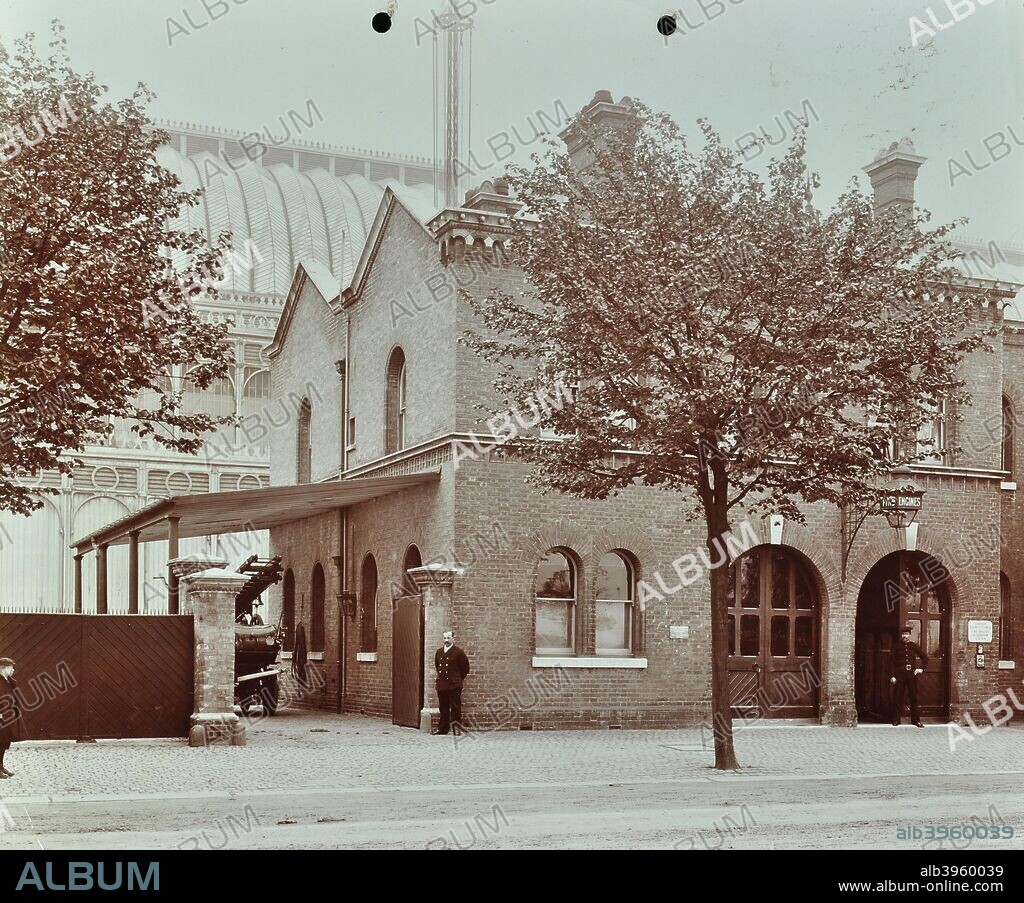 Sydenham Fire Station, Crystal Palace Parade, Lewisham, London, 1907. The fire station is shown with a fire engine and two firemen on duty. Behind is the Crystal Palace, burnt down in 1936.