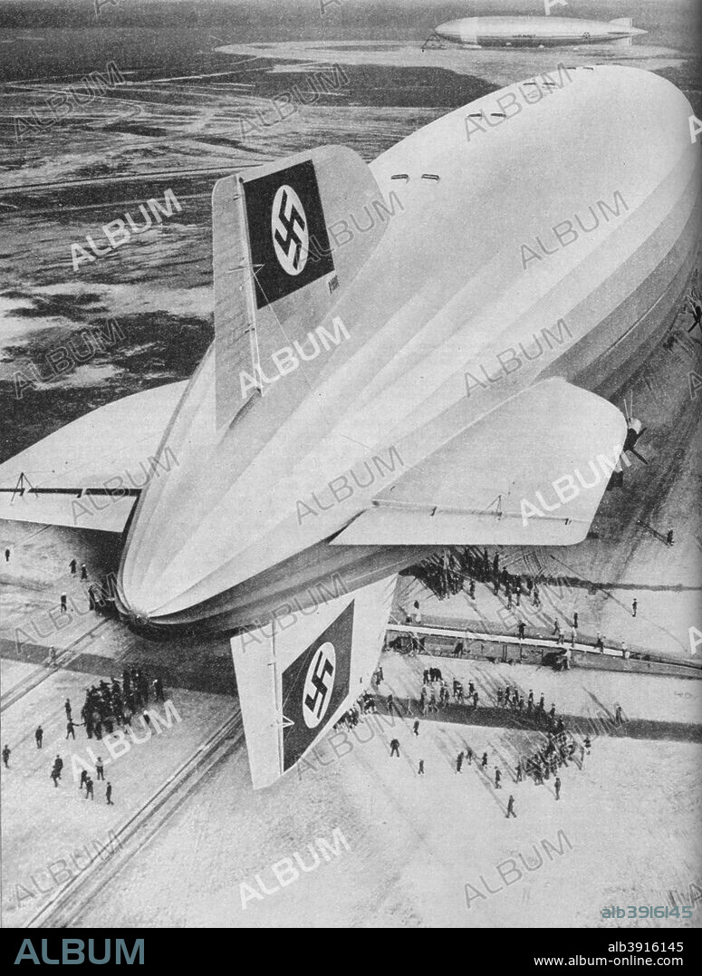 German Zeppelin airship 'Hindenburg' moored at Lakehurst, New Jersey, after a transatlantic flight, c1936 (c1937). The LZ 129 'Hindenburg' was a large German commercial passenger-carrying rigid airship that flew from March 1936 until it was destroyed in a disastrous accident 14 months later on May 6, 1937. The 'Hindenburg' made 17 round trips across the Atlantic in 1936. From Wonders of World Aviation, Vol. 1, by Clarence Winchester. [The Amalgamated Press Ltd, London, c1937].