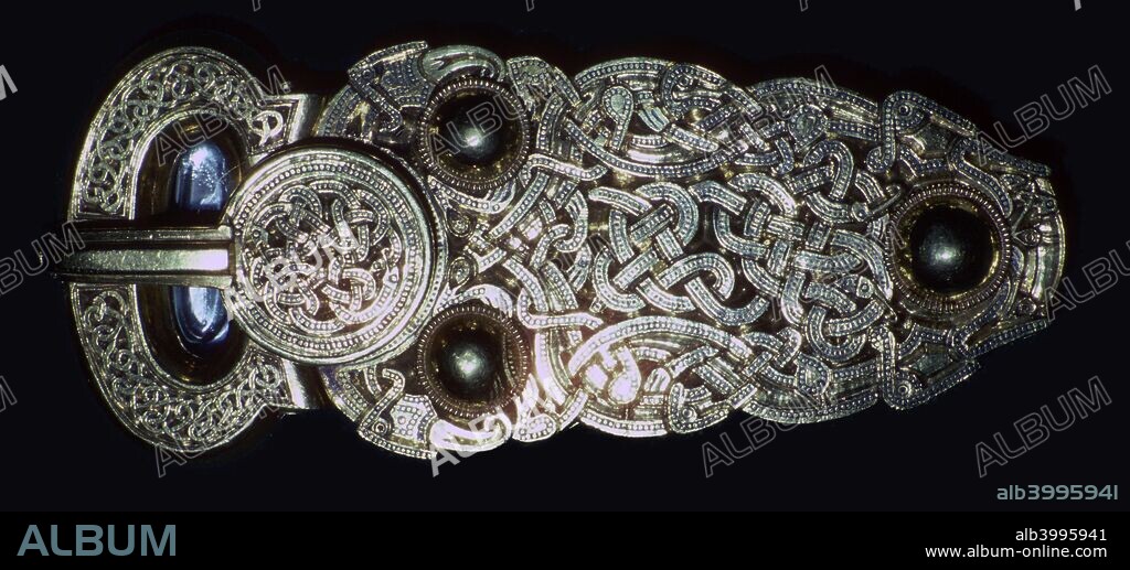 Gold belt buckle fom the ship-burial at Sutton Hoo, Suffolk, early 7th century. It is hollow and made in two parts joined by a hinge. The buckle is decorated with snakes, four legged beasts and birds. The  metal and decoration of these buckles reflected the wealth and status of their owners. From the British Museum.