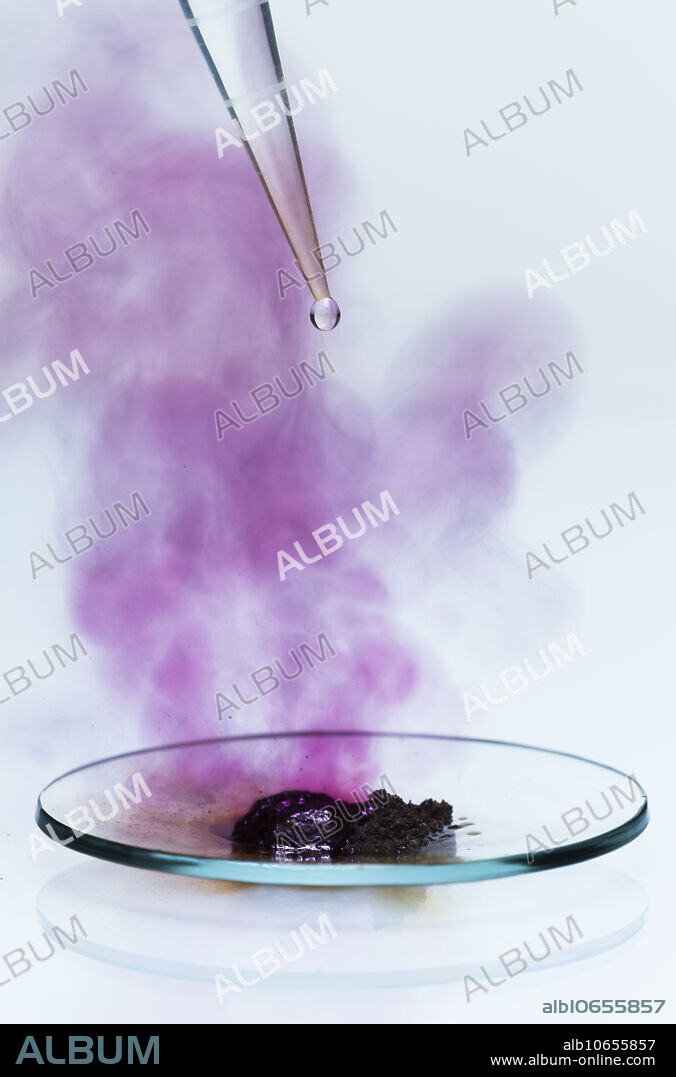 Aluminium reacts with iodine, 2 of 5. Powdered aluminium metal (Al) and iodine (I2) are mixed together and placed in a watch glass. A drop of water is used to initiate the synthesis reaction: Al + I2 -> Al2I6. It is an exothermic redox reaction that produces a lot of heat so that iodine sublimates and forms a violet vapour.