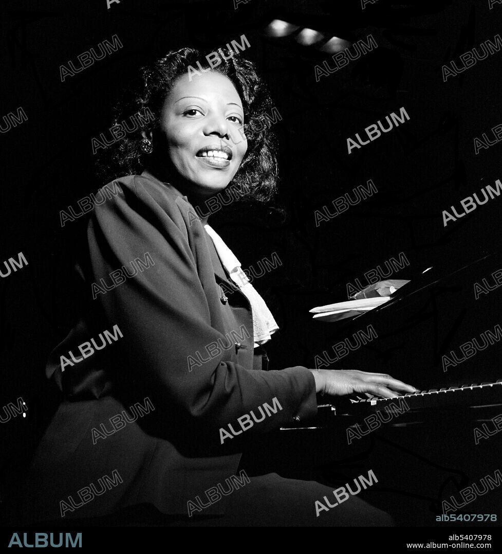 Mary Lou Williams (1910 - 1981) was an African-American jazz pianist, composer, and arranger who recorded over 100 records. She was briefly a pianist for Duke Ellington's Orchestra and composed and did arrangements for Benny Goodman, Tommy Dorsey and Earl Hines. She befriend, helped and taught many young jazz musicians. Photographed by William P. Gottlieb, CBS studio, NYC, 1947 (cropped and cleaned).