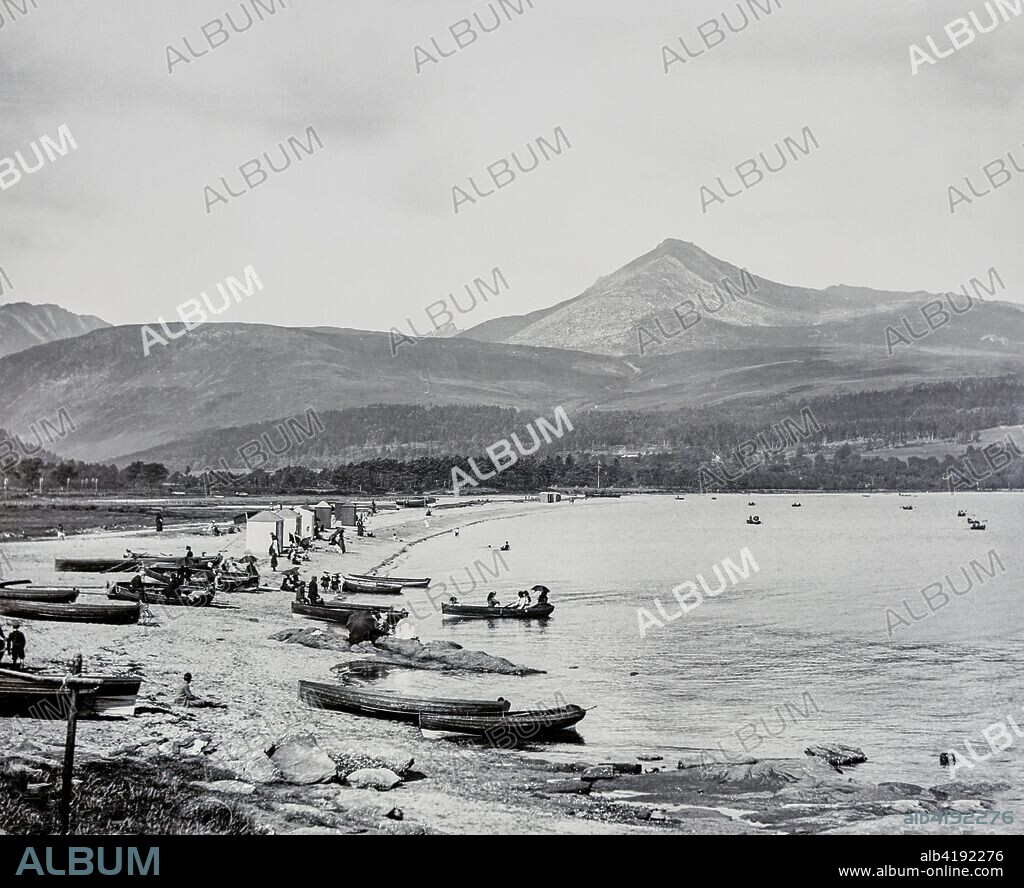 Magic lantern slide circa 1900.Victorian/Edwardian.Social History.Brodick (Scottish Gaelic: TrÃ igh a' Chaisteil ('Castle Beach') or Breadhaig) is the main town on the Isle of Arran, in the Firth of Clyde, Scotland. It is halfway along the east coast of the island, in Brodick Bay below Goat Fell, the tallest mountain on Arran. The name is derived from Norse roots meaning 'Broad Bay'. The harbour receives the main ferry between Arran and the mainland via Ardrossan. Brodick Castle is a former residence of the Dukes of Hamilton.  Brodick is one of the largest towns on the island and is seen as the main hub due to the ferry terminal which connects the island to the mainland. The town is host to many homes, hotels and shops, the health centre, nursing home, heritage museum, tourist information centre, Brodick Castle, and a public beach and park.