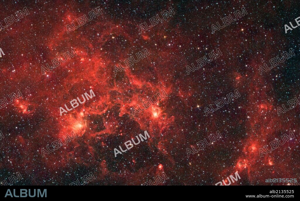 The nebula nicknamed "the Dragonfish." This turbulent region, jam-packed with stars, is home to some of the most luminous massive stars in our Milky Way galaxy. It is located approximately 30,000 light-years away in the Crux constellation. Spitzer. (Photo by: Universal History Archive/UIG via Getty Images).