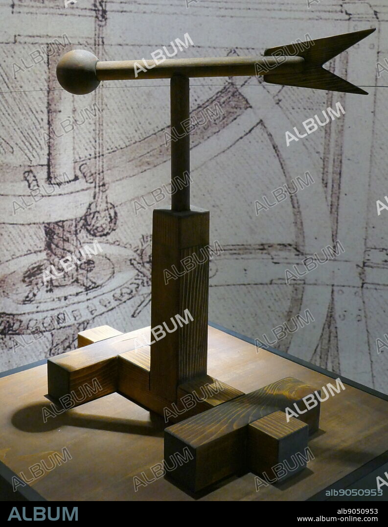 Model of an Anemoscope, used to identify wind direction; based on a drawing by Leonardo da Vinci (1452-1519), Italian artist and polymath; Codex Arundel folio 241 r. It consists of a wooden frame holding a vane rotating on a pin, with a round head at one end and a two-pronged tail at the other. As the vane turns, it shows the exact direction of the wind.
