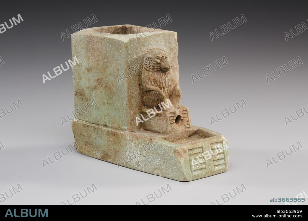 Water Clock Decorated with a Baboon. Dimensions: H. 5.7 × W. 3.1 × D. 7.2 cm (2 1/4 × 1 1/4 × 2 13/16 in.). Date: 664-30 B.C..
This piece is considered to be a model of a water clock. Water within could drain from a hole between the baboons legs over a measured time. This object was likely a temple offering to the god Thoth in his role as overseer of knowledge and measurement.