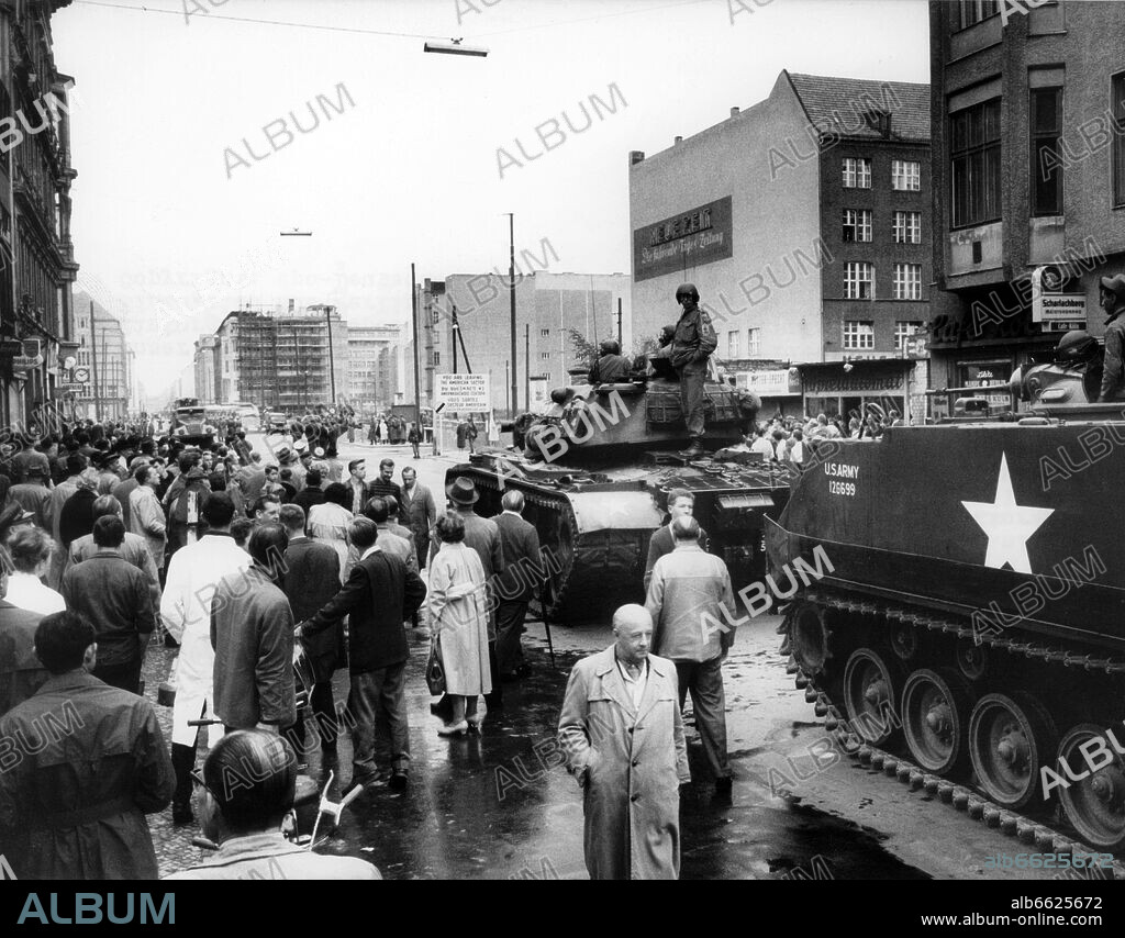 Tanks and soldiers of the US Army standing on the West Berlin side and the People's Police of the GDR, with a water gun, on the East Berlin side, at checkpoint Friedrichstraße in Berlin on 24th August 1961. From 13th August 1961, the day of the building of the wall, until the fall of Berlin Wall on 9th November 1989 the Federal Republic of Germany and the GDR were split by the 'iron curtain' between west and east. 24/08/1961