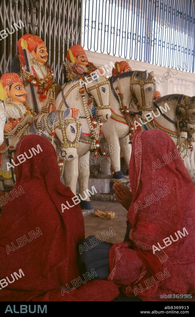 Jakh Botera, Jakhdada, Jakkha Bautera, 72 Yaksha or Bohter Yaksha, literally seventy-two Yaksha warriors, are a group of folk deities worshipped widely in the Kutch district of Gujarat.<br/><br/>. The Jakhs are said to have been shipwrecked on the Kutch coast and came ashore at a place now known as Jakhau. Described as tall and with fair complexions and an advanced culture, their traditional number is seventy-two with at least one woman.<br/><br/>. Kutch (often spelled Kachch) is the northwestern part of the Indian state of Gujarat, divided from the main part of the state by the Arabian Sea and a stretch of salt marshes. To its north lies the Pakistani province of Sind. The name Kutch is said to be derived from the Kachelas, a sub-caste of the <i>lohar</i> (blacksmiths) or <i>soni</i> (goldsmiths) castes.