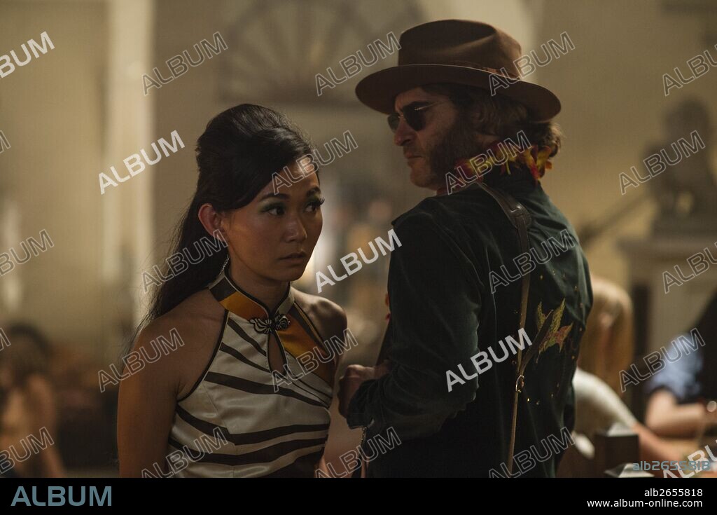 HONG CHAU and JOAQUIN PHOENIX in INHERENT VICE, 2014, directed by PAUL THOMAS ANDERSON. Copyright WARNER BROS. / WEBB, WILSON.