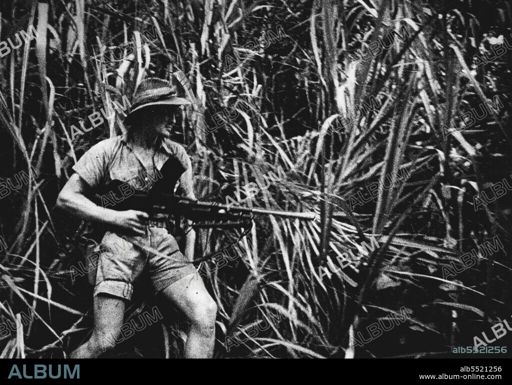 Latest Pictures Of Owen Stanley Ranges Fighting -- Australian John Hannam handles a Bren gun.Dept. of Information photo. For publication on or after passed by Censer afternoon, Wed. Sept. 23. September 24, 1942.