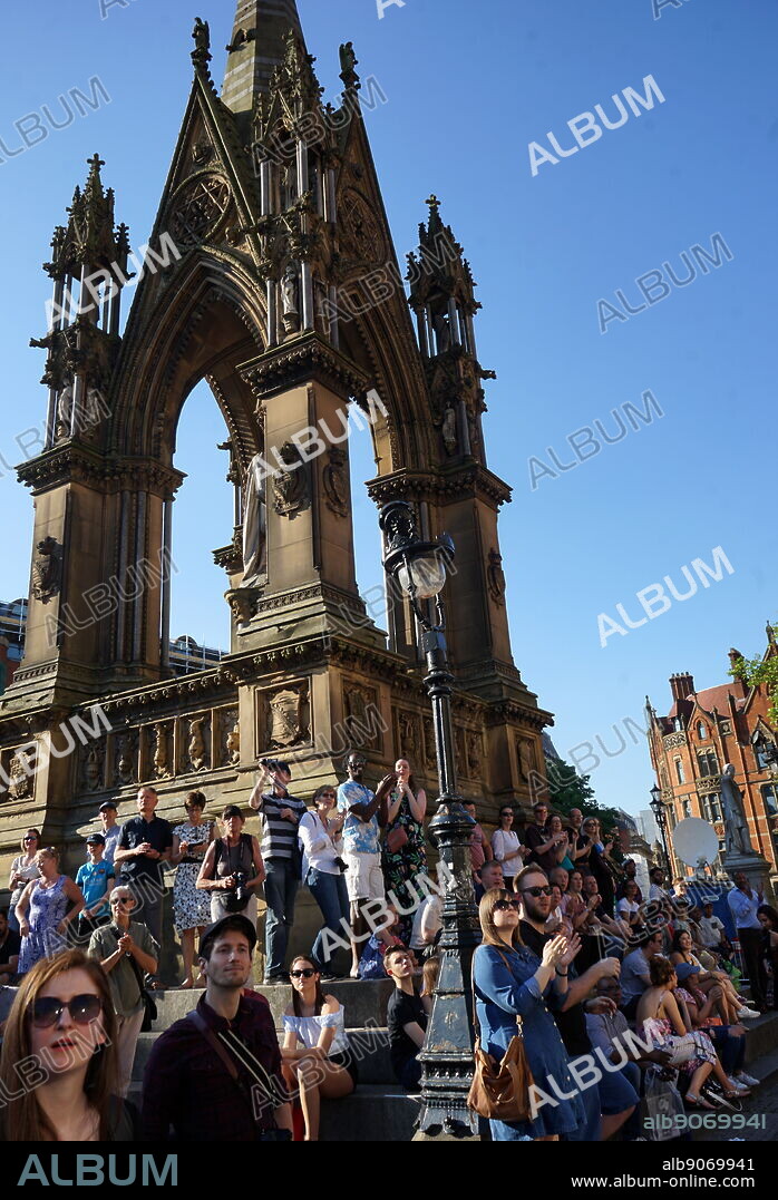In Manchester, England, Albert Square's largest monument is the Albert Memorial, commemorating the Prince Consort. It features a marble statue of Albert standing on a plinth and facing west, designed by Matthew Noble (18621867). The figure is placed within a large Medieval-style ciborium which was designed by the architect Thomas Worthington.