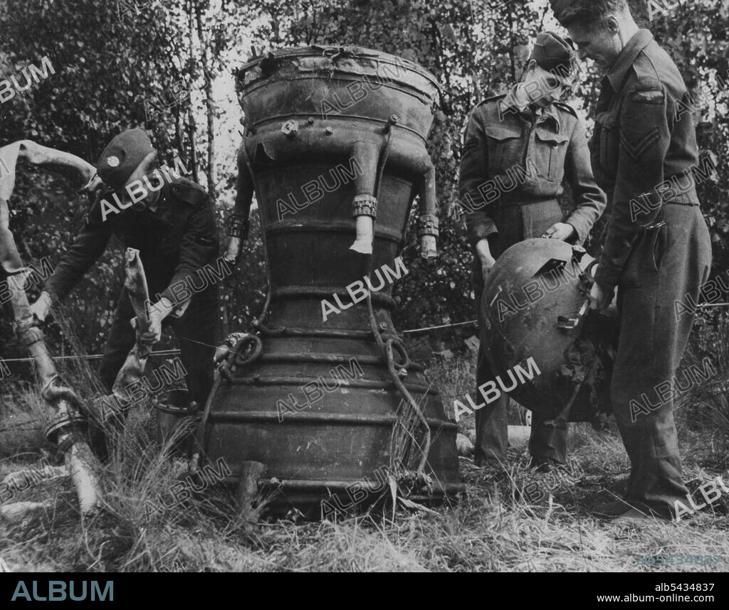 Another "V" -- Allied troops dismantling a German secret eapon, the jet unit Which ***** exploded in ***** Belgium. December 28, 1944. (Photo by Commonwealth Of Australia Department Of Air).