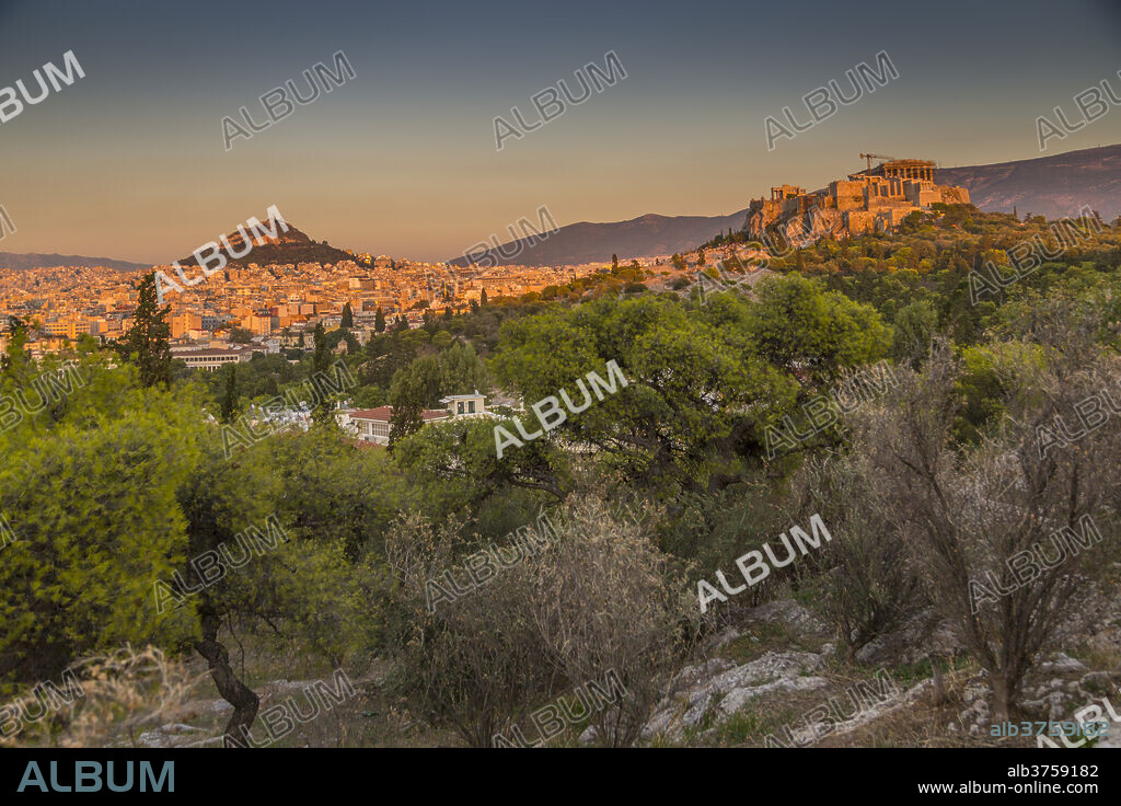View of The Acropolis and Likavitos Hill at sunset from Filopappou Hill, Athens, Greece, Europe.