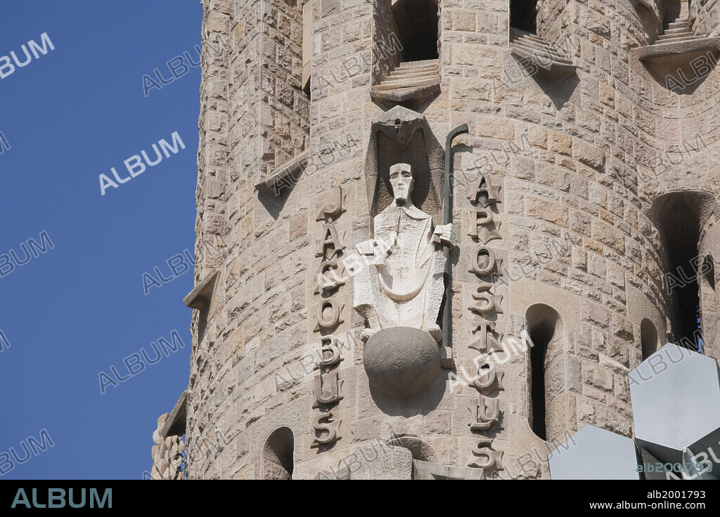 The construction of this unique Temple began in 1882, and one year later Antoni Gaudi was appointed Project Director. He worked on the project over 40 years until his death in 1926. The temple has three facades (named: 'Nativity', 'Passion' and 'Glory'), each bearing four souring towers. Eight of the twelve bell towers of the facades, dedicated to the Apostles and having a height exceeding 100 meters, are already built. The four belfries awaiting construction are those of the Facade of Glory, the 170-meter central dome in honor of Jesus Christ, the Tower of the Virgin Mary (125m) and the Tower of the 4 Evangelists. The four towers over the Passion Facade (southwestern lateral facade) represent the Apostles James (Jacobus), Bartholomew, Thomas and Philip. Seen here is the statue of the Apostle James (Jacobus) at a height of 148 feet on his respective bell tower. The statues of the Passion Facade are by the sculptor Josep Maria Subirachs. Subirachs began his work in 1987 following the ideas of Gaudi, but not his style.