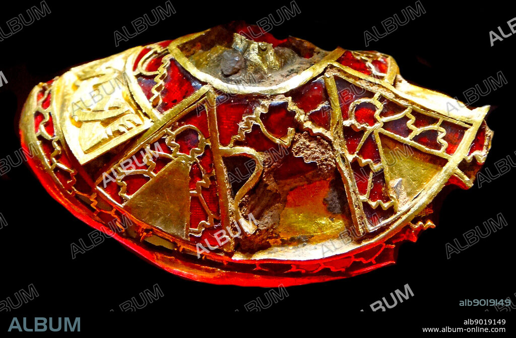 part of the boss from a shield, the lid to a Christian chalice, or the stopper to a drinking horn. from the Staffordshire Hoard. decorated with very fine cloisonné garnet work, small gold panels with pairs of biting beasts and, at the top, a glass gem. The Staffordshire Hoard is a collection of Anglo-Saxon. Discovered in a field near the village of Hammerwich, near Lichfield, in Staffordshire, England, in 2009. it consists of over 3, 500 items, dated to the 7th or 8th centuries, placing the origin of the items in the time of the Anglo-Saxon kingdom of Mercia.