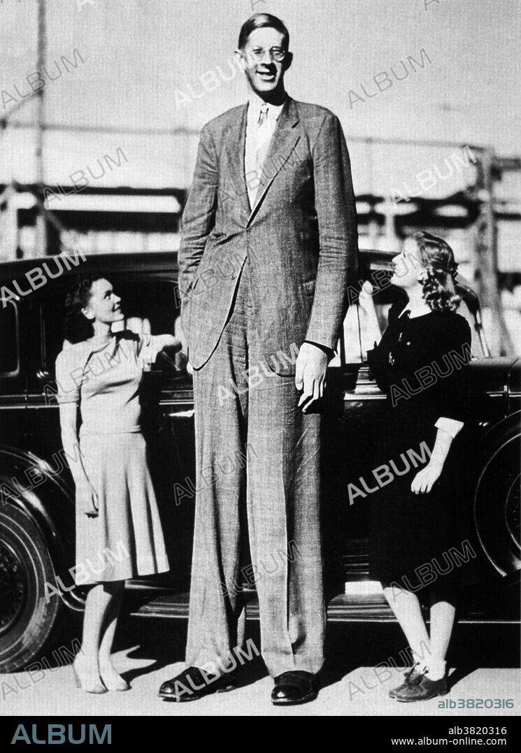 Robert Pershing Wadlow (1918-1940). Born in Alton, Illinois, he remains, to this day, the tallest man in medical history. He is seen here with actresses Maureen O'Sullivan (left) and Ann Morris (right). By the time of his death, Wadlow had grown to 8 feet 11.1 inches.