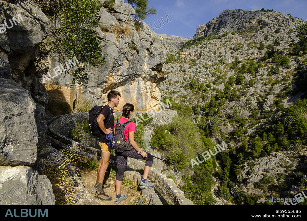 couple walking on the path,Solleric canal,torrent d'Almadrà, Alaró, , 18th century,Majorca, Balearic Islands, Spain.