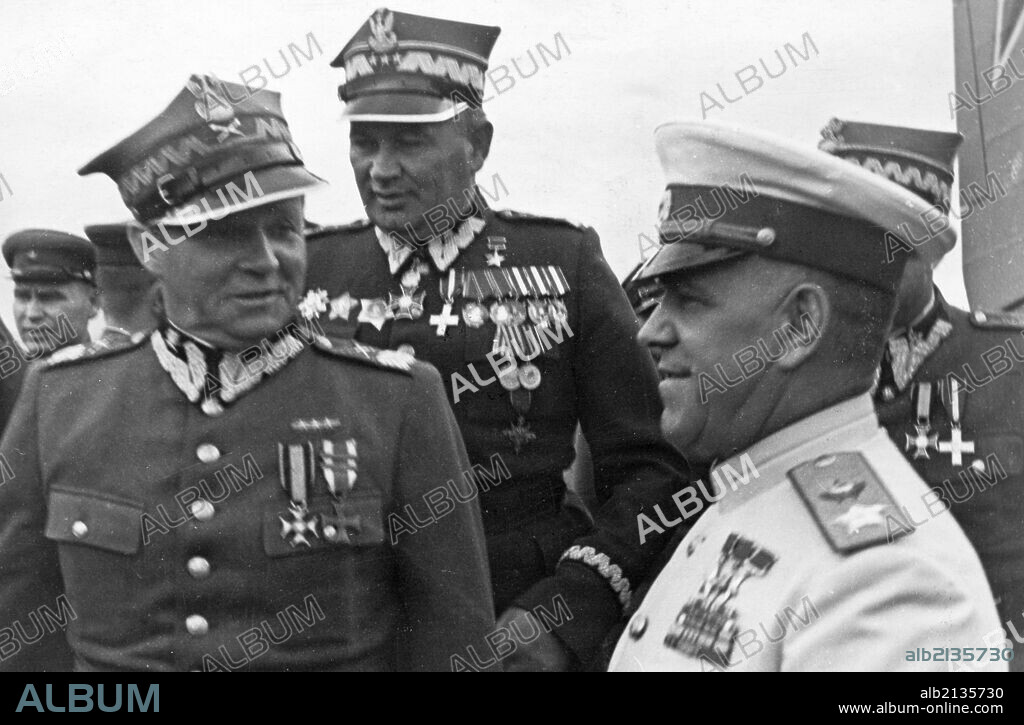 Marshals georgy zhukov and rokossovsky receive highest awards from the polish military, marshal m, rola-zymierski, commander-in-chief of the polish army, zhukov, and colonel-general s, poplawski at the warsaw aerodrome, 1945, world war 2.