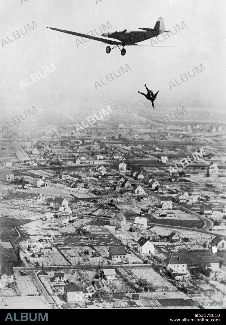Germany:  May 24, 1931 Willi Ruge is endeavoring to take the first sky diving self portraits as he leaps from a plane with a parachute. Here he dives head first out of the airplane to give his colleague Herr Boettcher the best effect for his photograph.   © Underwood Archives / The Image Works.