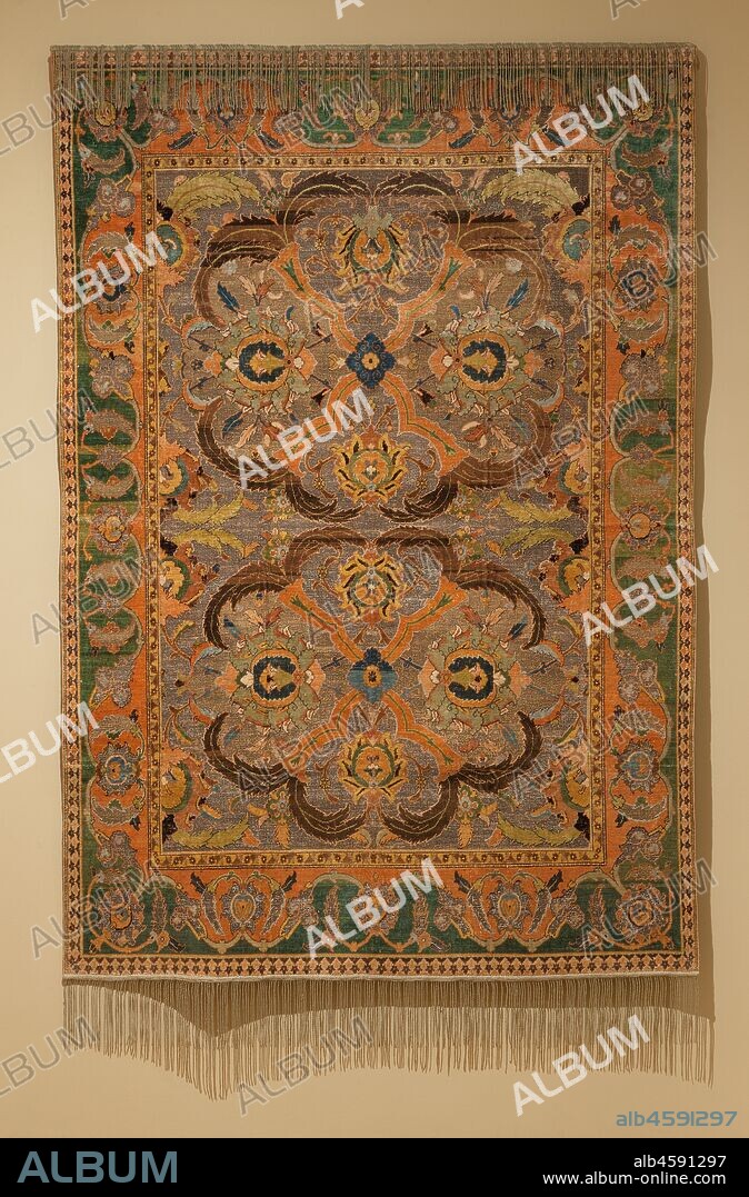 Royal Carpet with Silk and Metal Thread , 1600-1625. Brilliant colours of silk carpet-pile form this rich foliate and floral pattern on (originally shiny) gold- and silver-thread grounds. This radiant Iranian carpet was woven in a royal workshop of Shah ?Abbas I in Isfahan. The Shah presented similar coveted carpets as imperial gifts to kings of Islamic and Christian countries. In Denmark, one carpet looks sparkling new because it is reserved for coronations. This group with silk and metal thread is mistakenly called "Polish," based on one displayed in the Polish exhibit at the Paris World Fair in 1878. Unlike these opulent carpets, most 16th- and 17th-century Iranian carpets were woven with wool, many of which served as models when the industry was revived in the late 19th century.