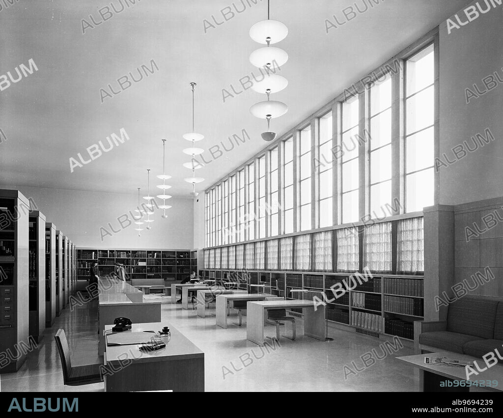 Interior view of the Library Reading Room at the Cranbrook Academy of Art in Bloomfield Hills, Michigan, November 16, 1943. Students are visible reading at desks in the background. Photographed for architect Eliel Saarinen and Pencil Points.