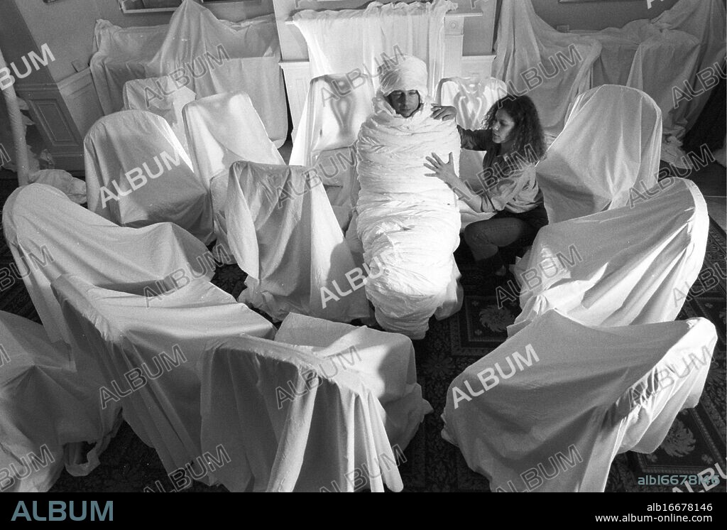 Pallant House Gallery, Chichester. Sculptor Susan Stockwell wraps David Coke, the curator of Pallant House Art Gallery, in toilet paper after wrapping 18th century furniture from the gallery in other fabrics as part of an installation for the Chichester Festivities (it was what they called their festival). 10 July 1996. Picture by Roger Bamber.