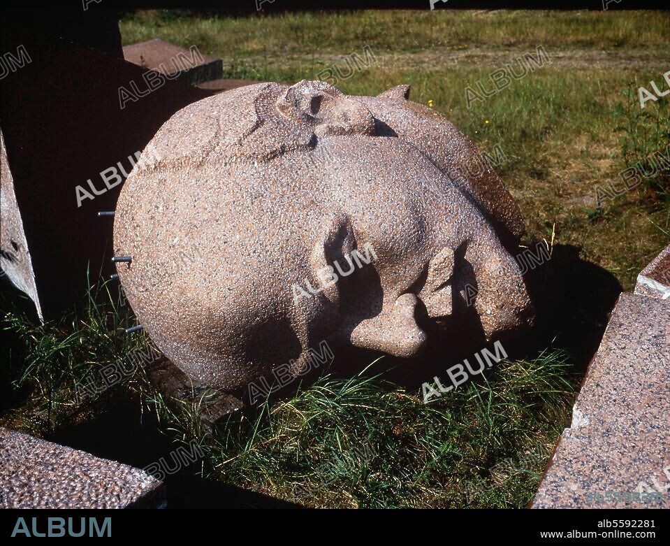 zu: Berlin-Friedrichshain, Lenin-Denkmal, Leninplatz. (1970 errichtet von Nikolaij Tomski; 1991 abgetragen). Lagerung der Segmente des Lenin-Denkmals in einer Sandgrube in den Müggelbergen bei Berlin-Köpenick: Der Kopf. Foto, Juni 1992.