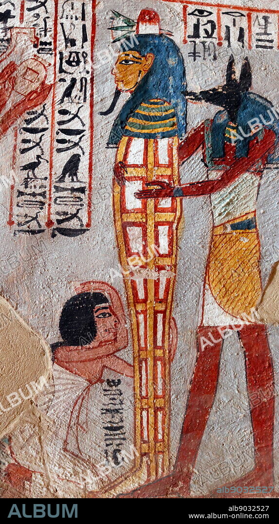 The God Anubis holds a sarcophagus; Wall painting inside the Theban Tomb of Roy (TT255), in Dra' Abu el-Naga'. It forms part of the Theban Necropolis, situated on the west bank of the Nile opposite Luxor. The sepulchre is the burial place of the Ancient Egyptian official, Roy, who lived at the end of the 18th dynasty, during the reign of Horemheb. Roy was a Royal Scribe in the Estates of Horemheb and of Amun. His wife, who appears with him in the tomb paintings, is named as Nebtawy, or 'Tawy'.