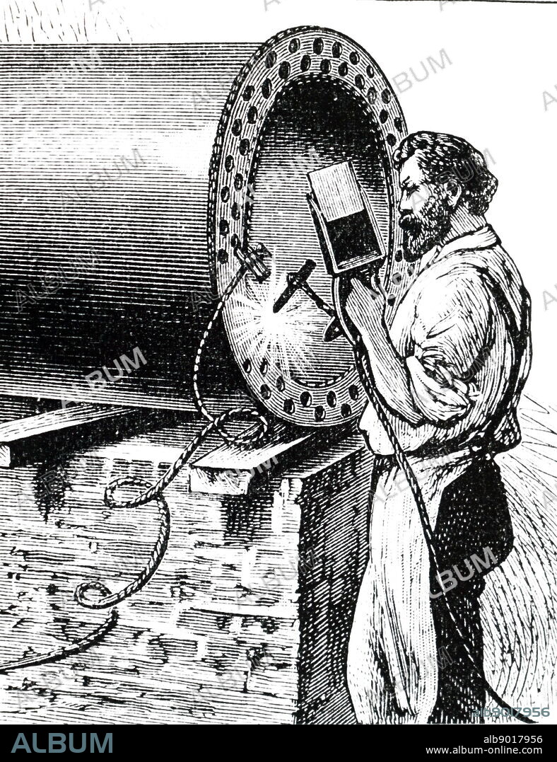 An engraving depicting the arc welding using an apparatus invented by Nicolas de Bernardo and Stanislaw Olszewski of St Petersburg. The equipment was DC and was powered by a battery or dynamo. The operator is holding the carbon in one hand and coloured glass to protect his eyes in the other. Dated 19th century.