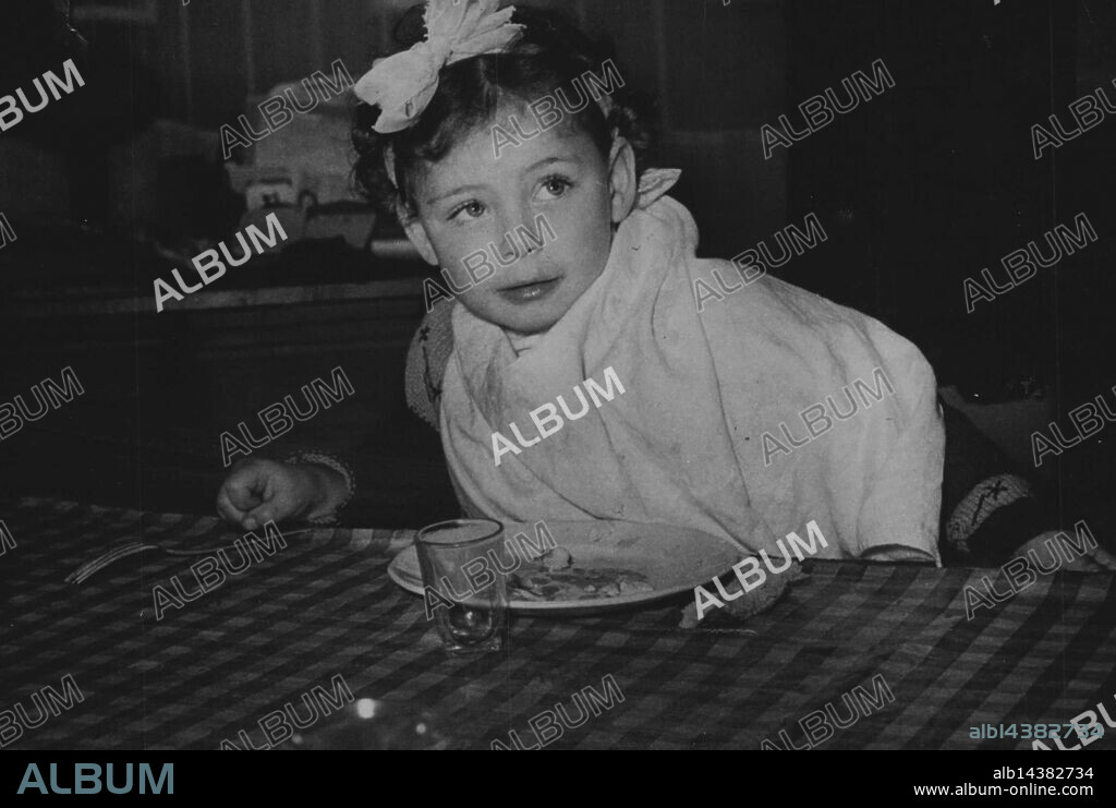 Adopted. Not everybody would have the courage to adopt Pierrette Paul, whose mother, Sylvie Paul, is on trial for murder. Mrs. Paul has become known as the "Wall Murderess." She is alleged to have murdered in Paris an hotel proprietress whose body was discovered walled up in a cellar. M. and Mme. Bilibo of Algiers, will adopt Pierrete. October 23, 1951. (Photo by Paul Popper Ltd.).