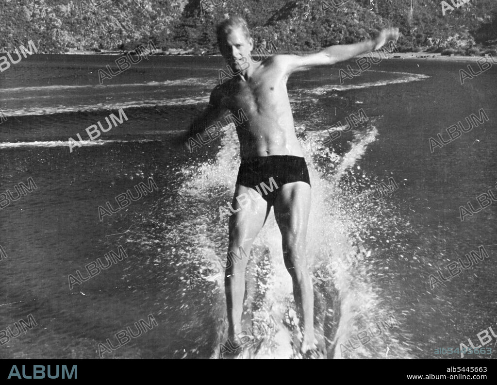 Lt. Cdr. The Duke of Edinburgh With The Royal Navy -- These photographs were taken during the Mediterranean Fleet's summer cruise - Prince Philip's last cruise in H.M.S. Magpie before he returned to the United Kingdom in August. A favourite sport in the Mediterranean Fleet is water-skiing. This shot was taken from a beach at Marmarice in Turkey: Having let go the tow the Duke of Edinburgh ends up on beach. By a private photographers by permission of the Duke of Edinburgh. Prince Philip water-skiing in Turkish waters when with the fleet. August 5, 1951. (Photo by Camera Press).