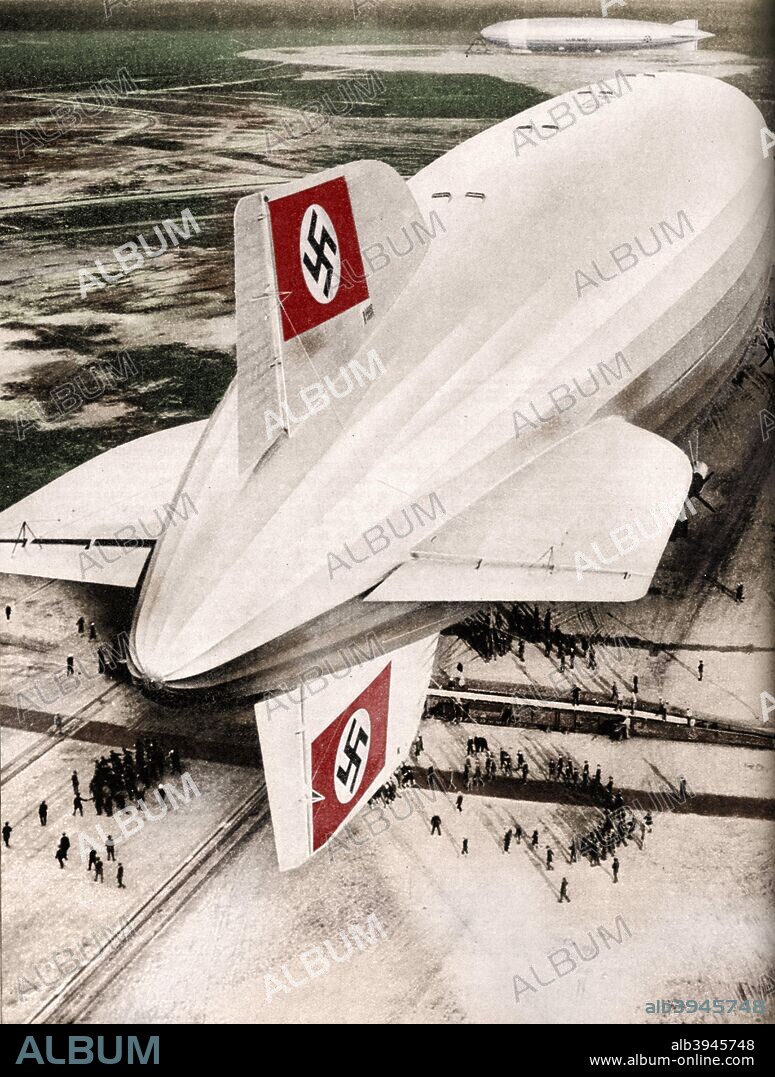 German Zeppelin airship 'Hindenburg' moored at Lakehurst, New Jersey, after a transatlantic flight, c1936 (c1937). The LZ 129 'Hindenburg' was a large German commercial passenger-carrying rigid airship that flew from March 1936 until it was destroyed in a disastrous accident 14 months later on May 6, 1937. The 'Hindenburg' made 17 round trips across the Atlantic in 1936. From Wonders of World Aviation, Vol. 1, by Clarence Winchester. [The Amalgamated Press Ltd, London, c1937]. (Colorised black and white print).