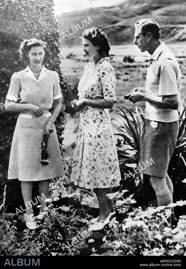 Photograph of King George VI with his two daughters, Princess Margaret (left) and Princess Elizabeth (centre). George VI (1895-1952) King of the United Kingdom and the Dominions of the British Commonwealth, the last Emperor of India and the first Head of the Commonwealth. Princess Margaret, Countess of Snowdon (1930-2002). Princess Elizabeth (1926-) Queen of the United Kingdom, Canada, Australia and New Zealand. Dated 20th Century.