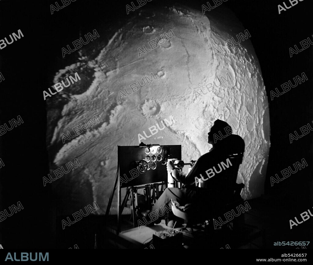 Apollo Project flight simulator, USA, 1960s. NASA's Lunar Orbit and Let-Down Approach Simulator (LOLA), a high-tech simulator designed to represent the view an Apollo astronaut would see if they were looking at the lunar surface just prior to establishing orbit of the Moon. The simulator was built at the Langley Research Center in Hampton, Virginia, and was comprised of a cockpit, a closed-circuit television system and four large murals or scale models which represented portions of the lunar surface as seen from various altitudes.