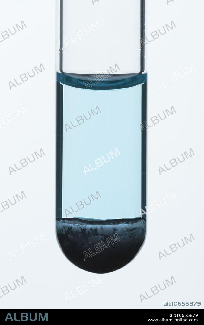 Copper (II) oxide reacts with hydrochloric acid. Black copper (II) oxide (CuO) reacts slowly with 1 M hydrochloric acid (HCl) at room temperature, producing blue solution of copper (II) chloride (CuCl2) and water: CuO + HCl -> CuCl2 + H2O. This photo was taken after solid copper (II) oxide has been in the acid for a day while being periodically shaken.