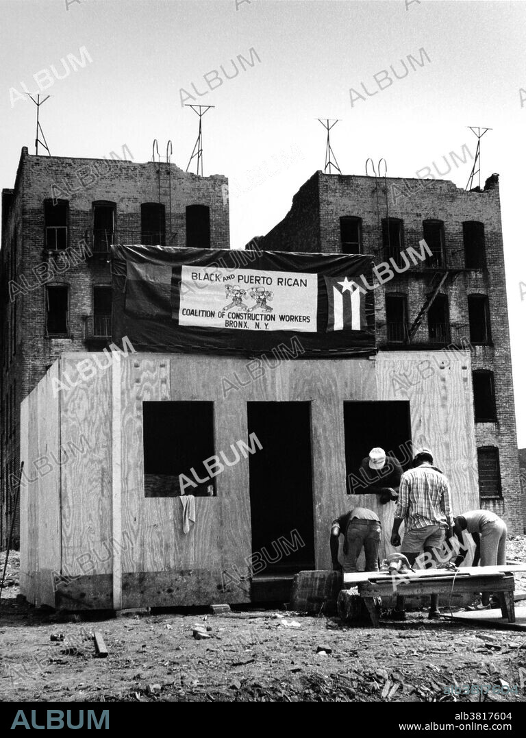 A demonstration for employment and housing on Charlotte Street in the South Bronx in the 1980s, staged prior to a presidential visit. The sign reads "Black and Puerto Rican Coalition of Construction Workers, Bronx, N.Y.".