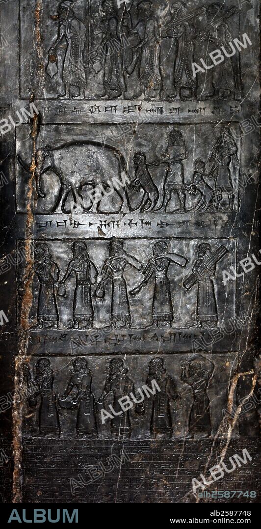 The Black Obelisk of Shalmaneser III (858-824 BC) Assyrian, about 827 BC. The obelisk was erected in the centre of Nimrud, shortly before Shalmaneser III's death.  It records the king's campaigns, showing tribute brought from all directions.  The stone itself is a fine-grain black limestone streaked with white.