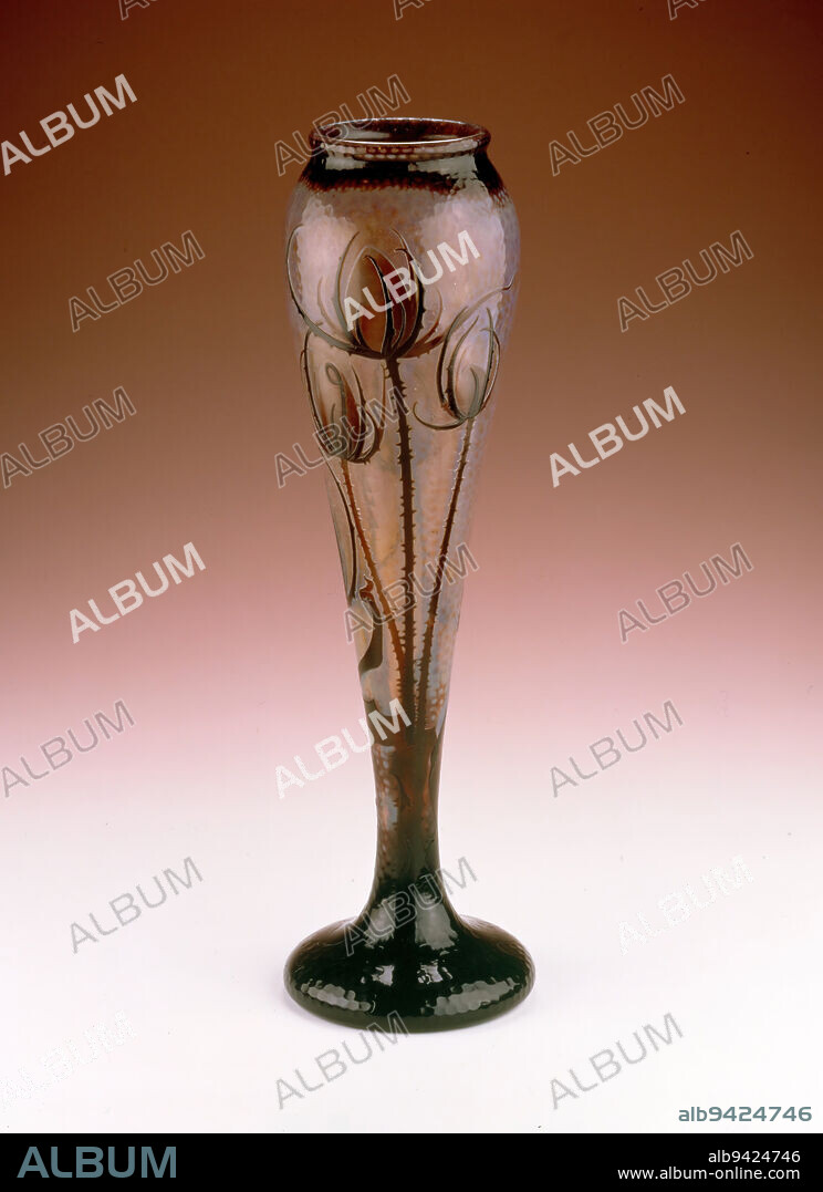 Vase, c. 1895, Daum Frères, French, Nancy, France, 1878-present, 20 1/16 x 6 in. (50.96 x 15.24 cm), Acid polished, etched, and polished glass, France, 19th century, Similar to Tiffany in America, the Daum Frères firm in France gained international recognition for its mastery of Art Nouveau designs. Among the wide variety of glass manufactured by the Daum family firm, the best known are their stylized organic forms created through carving encased glass. As seen in this vase, a bitumen-resist was painted on the glass to depict thistle and floral motifs, and then the vase was placed in hydroflouric acid to reduce unpainted areas. The process was repeated to create the textured layers of the design. Daum's knowledge and skill with glass earned a grand prize at the Paris International Exhibition in 1900. About the same time, Daum united with the firms of Emile Gallé (glass), Louis Majorelle (furniture), and Victor Prouvé (interior design) to create the Alliance Provinciale des Industries d'Art (later named École de Nancy), which fostered art production in Nancy.